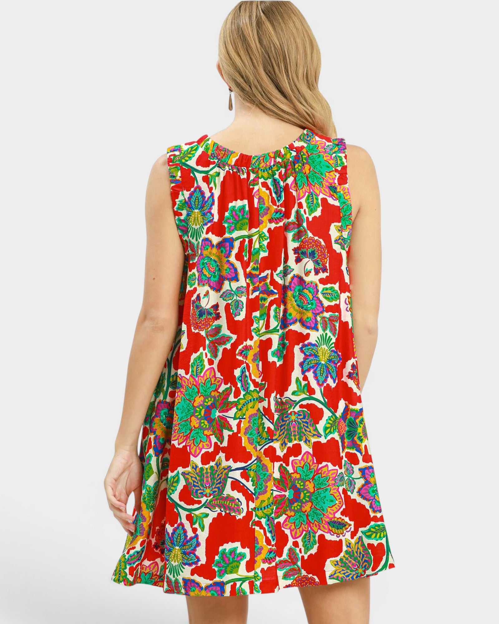 Woman wearing a colorful floral dress on a white background