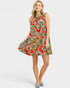 Woman wearing a colorful floral dress on a white background