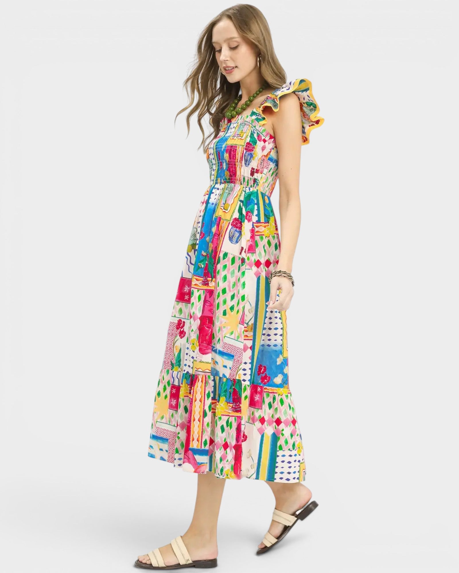Woman wearing a colorful patterned dress on a white background