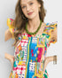 Woman wearing a colorful patterned dress with a necklace on a plain background