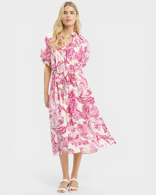 Woman wearing a pink and white floral dress on a white background