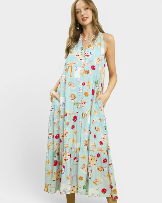 Woman wearing a light blue dress with colorful pattern on a white background