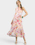 Woman wearing a colorful floral dress on a white background