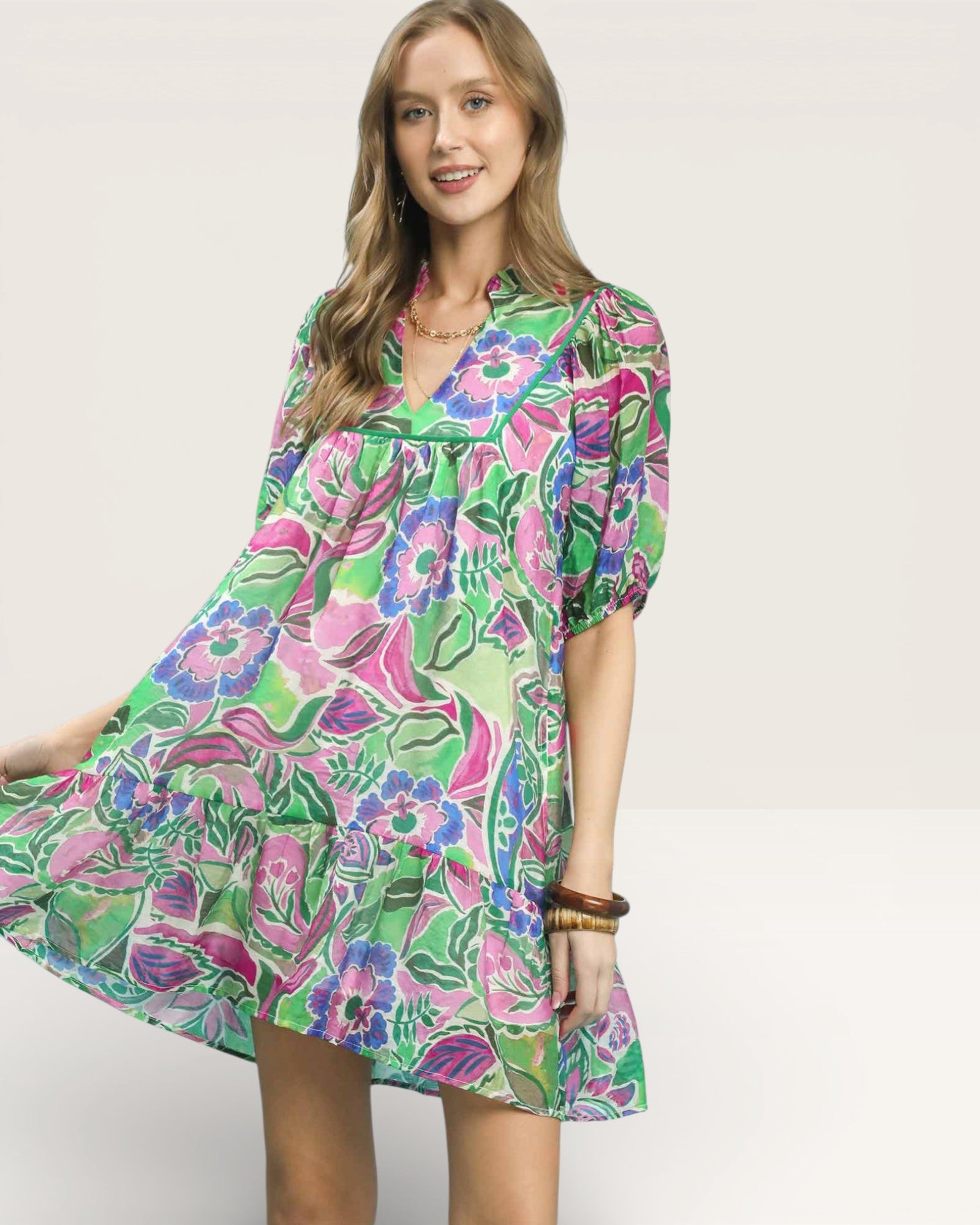 Woman wearing a colorful floral dress on a white background