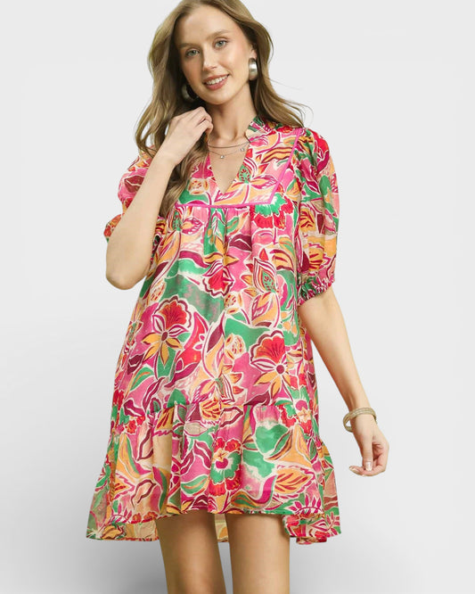 Woman wearing a colorful floral dress on a white background