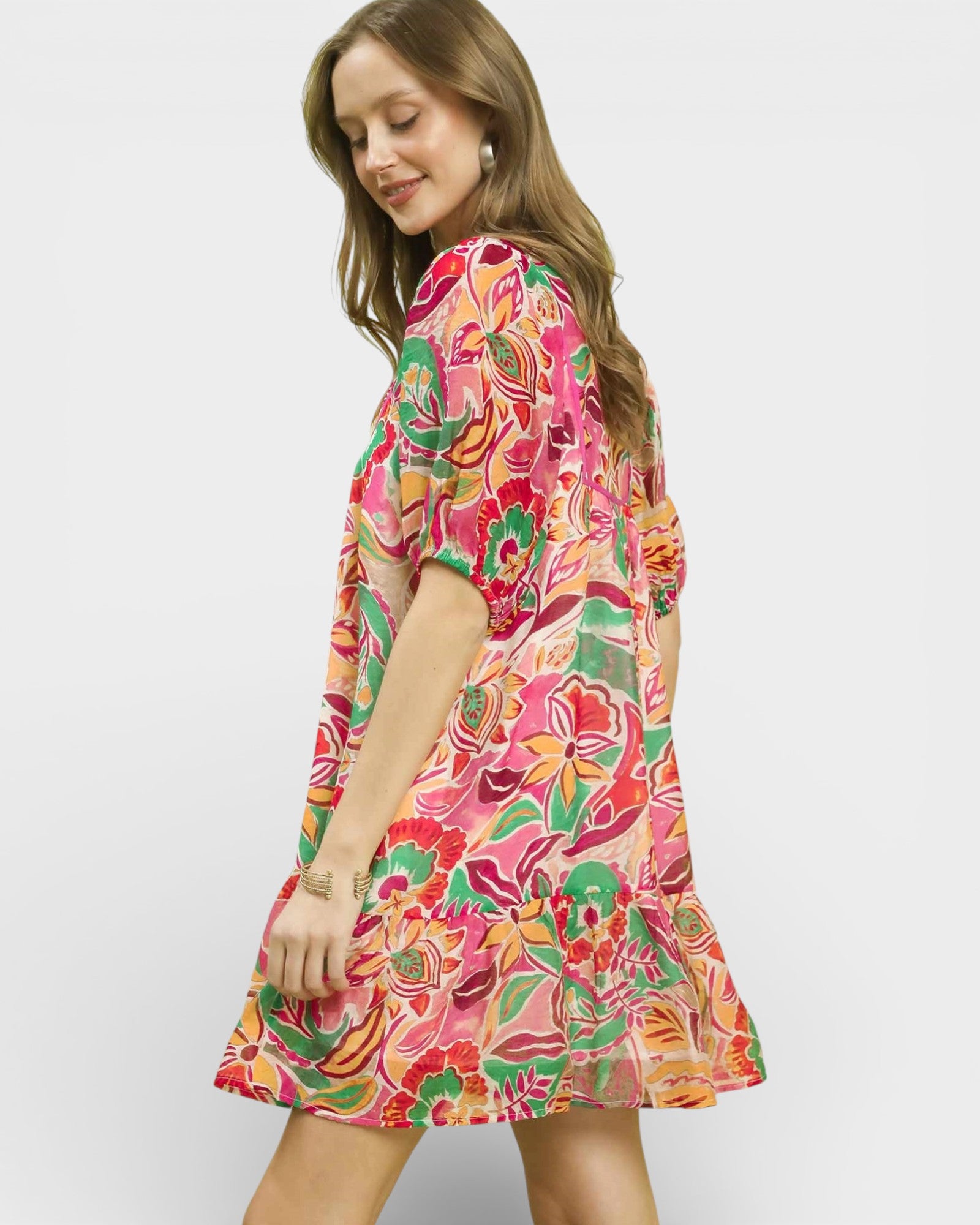 Woman wearing a colorful floral dress on a white background