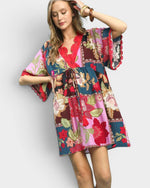 Woman wearing a colorful floral dress on a white background