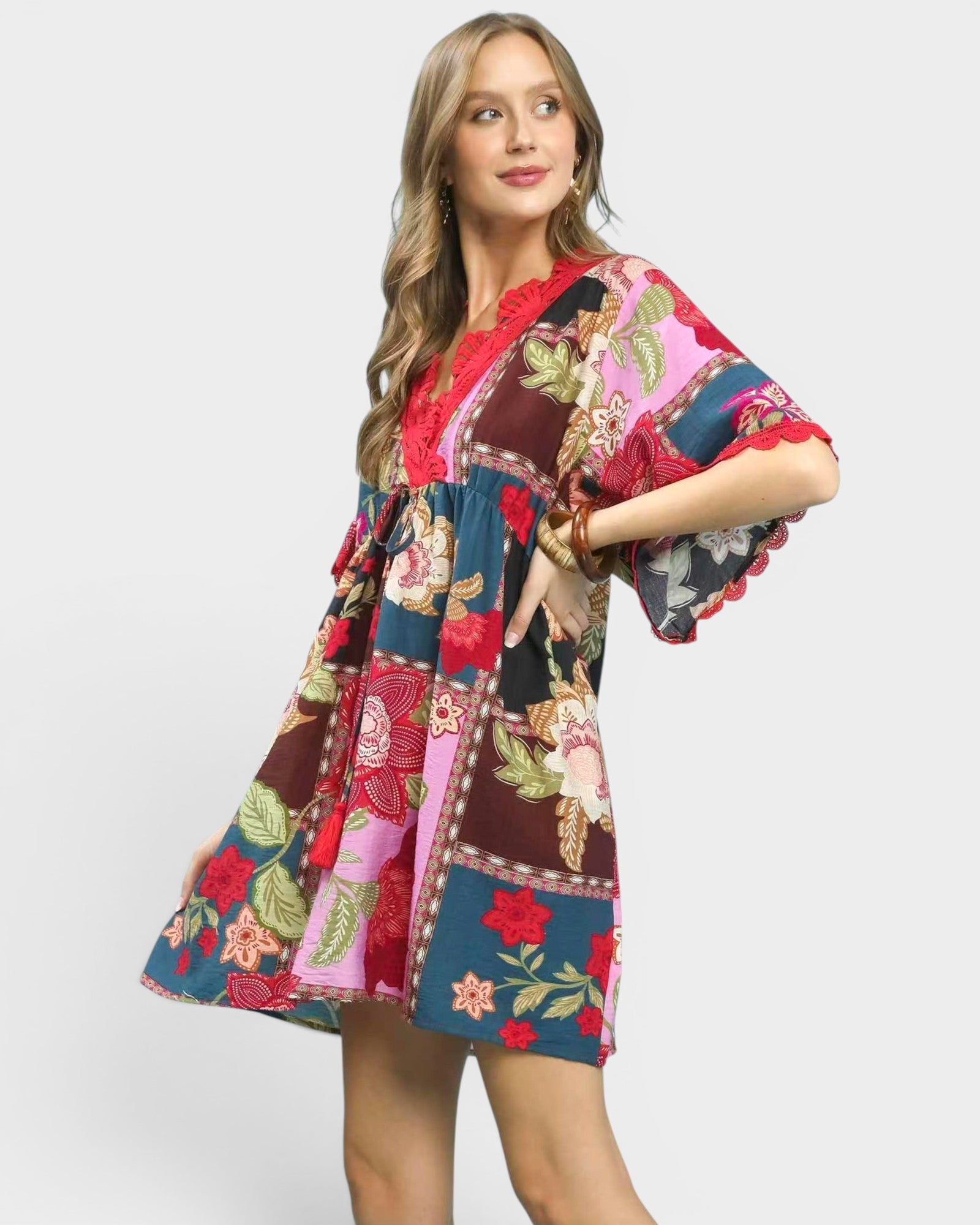 Woman wearing a colorful patchwork dress on a white background