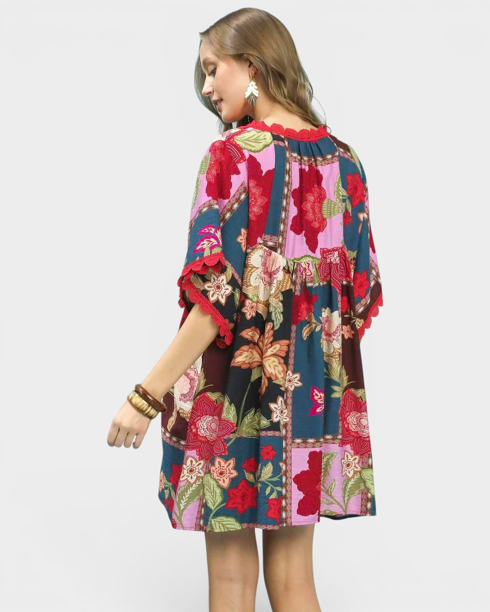 Woman wearing a colorful floral dress on a white background