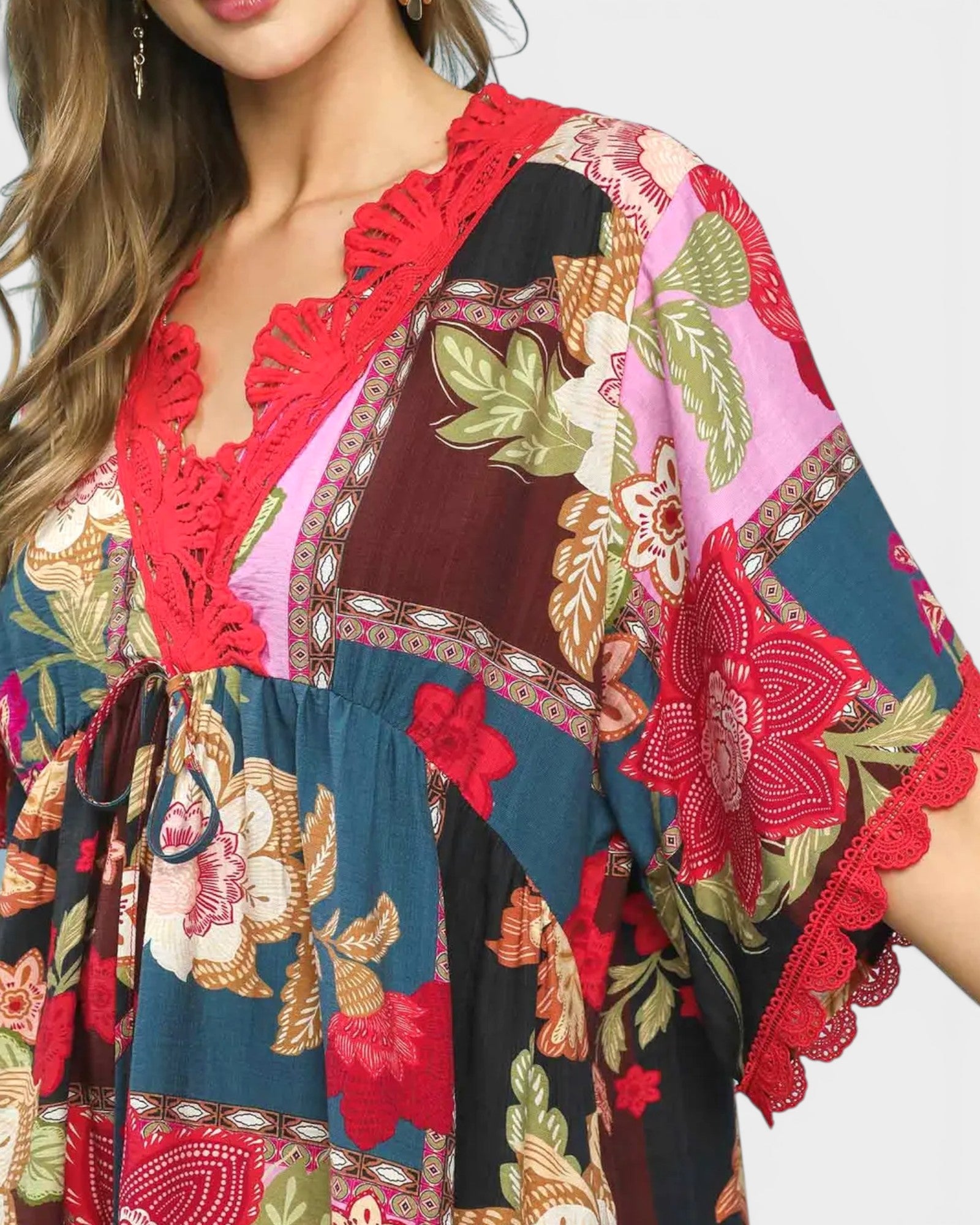 Colorful patterned dress with red accents on a plain background