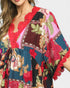 Colorful patterned dress with red accents on a plain background