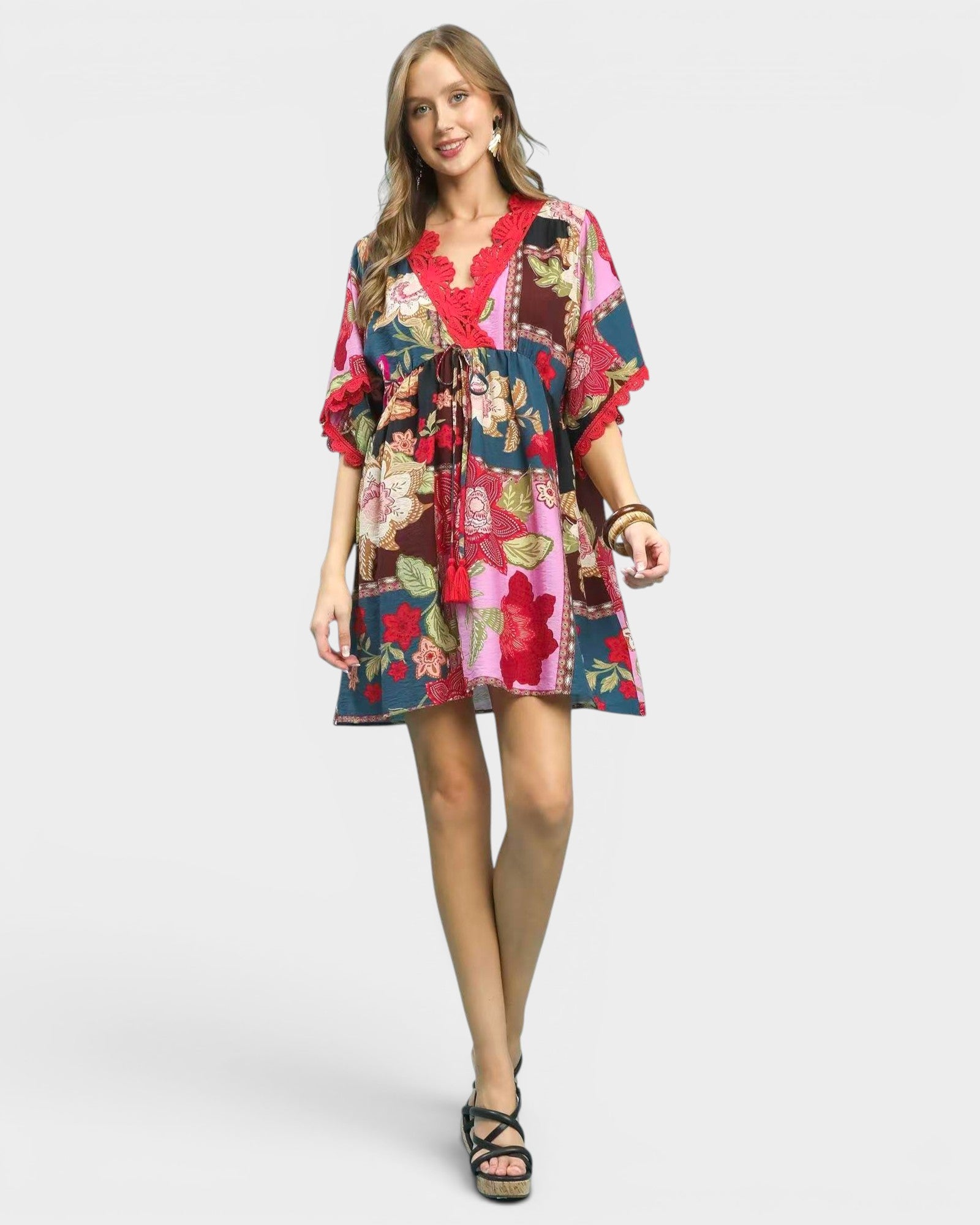 Woman wearing a colorful floral dress on a white background