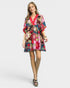 Woman wearing a colorful floral dress on a white background