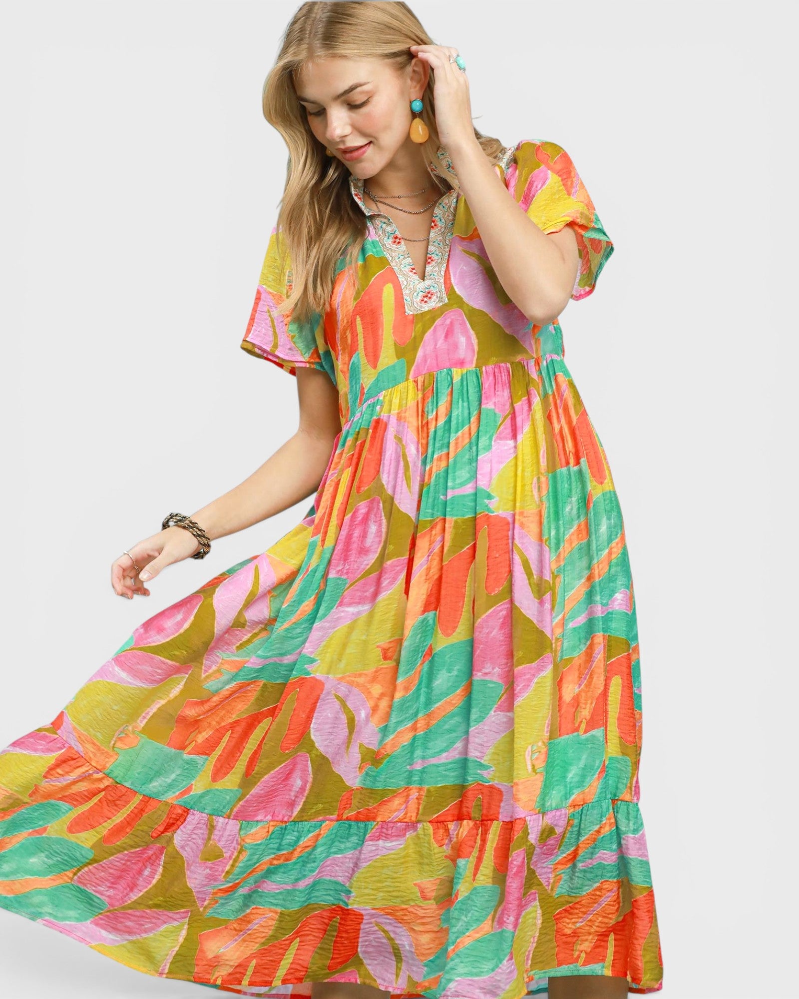 Woman wearing a colorful patterned dress on a white background