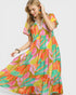 Woman wearing a colorful patterned dress on a white background