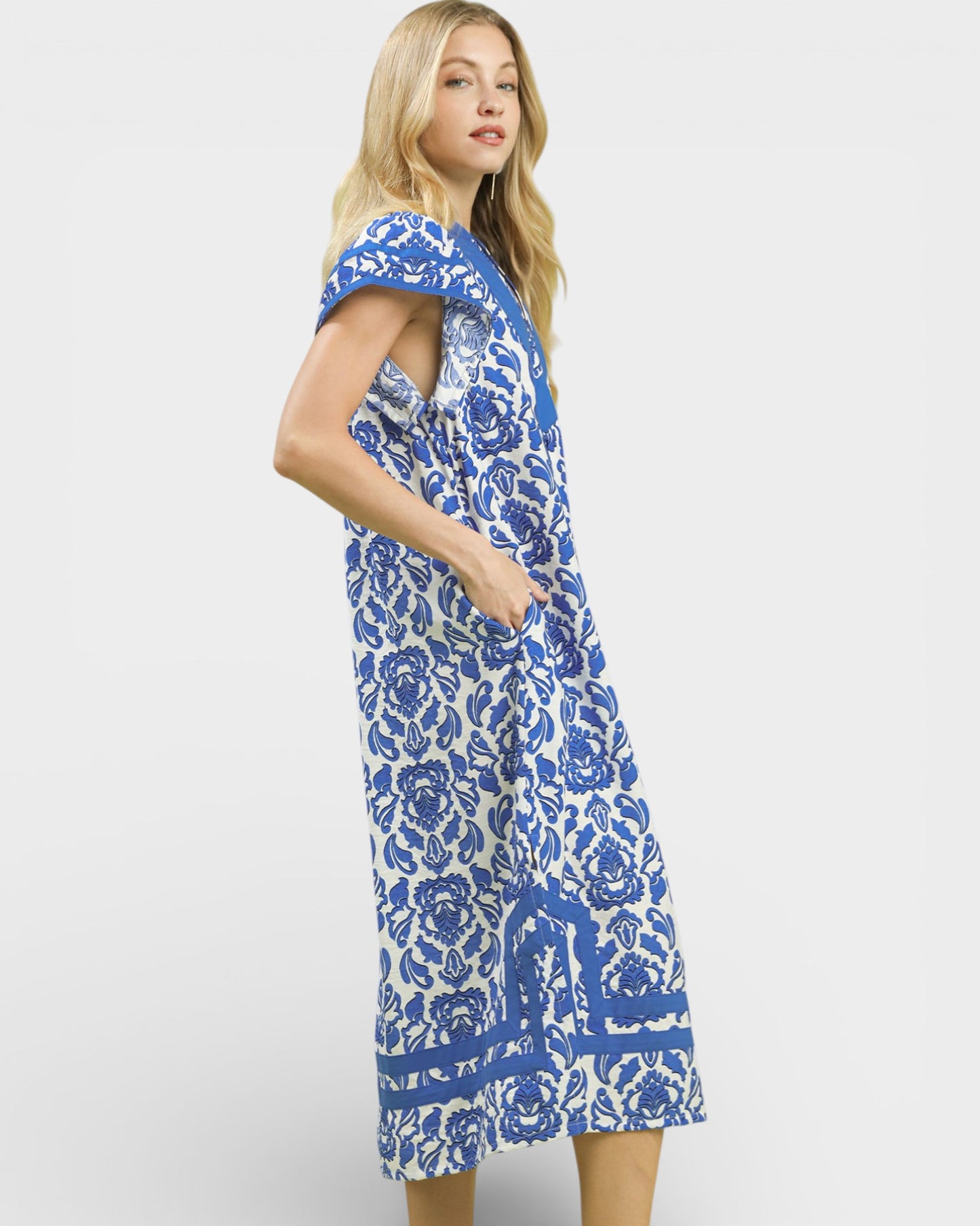 Woman wearing a blue floral dress on a white background