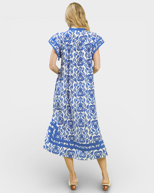 Woman wearing a blue and white floral dress on a white background