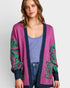Woman wearing a colorful cardigan with a white background