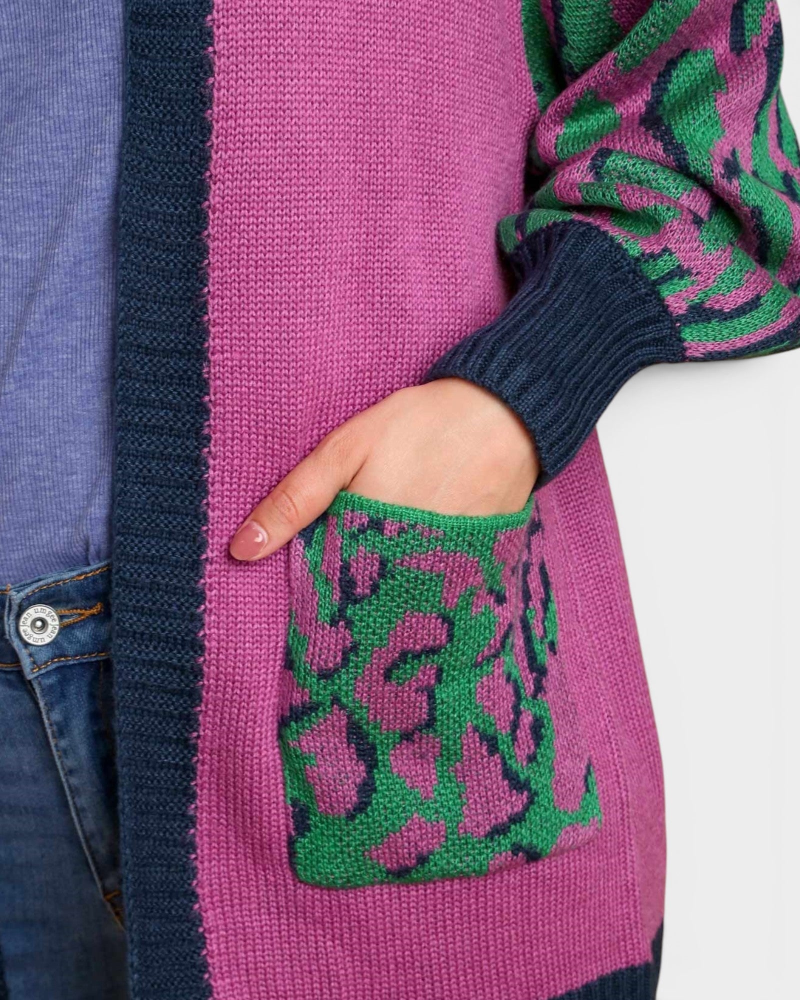 Close-up of a person wearing a colorful sweater with a patterned pocket.