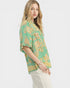 Woman wearing a green floral blouse on a white background
