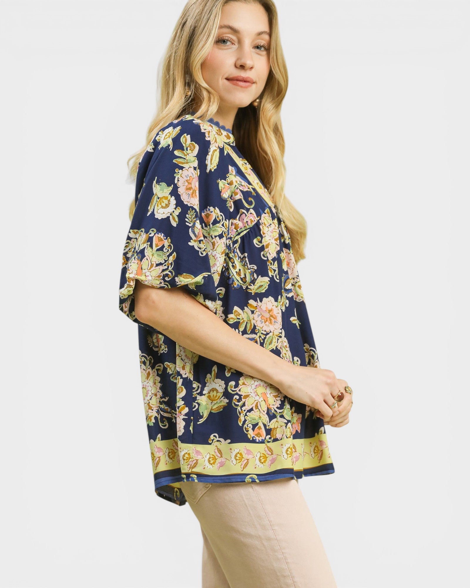 Woman wearing a floral kimono-style top on a white background