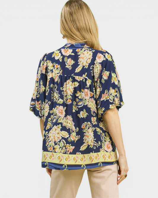 Woman wearing a floral blouse with a plain background