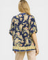 Woman wearing a floral blouse with a plain background