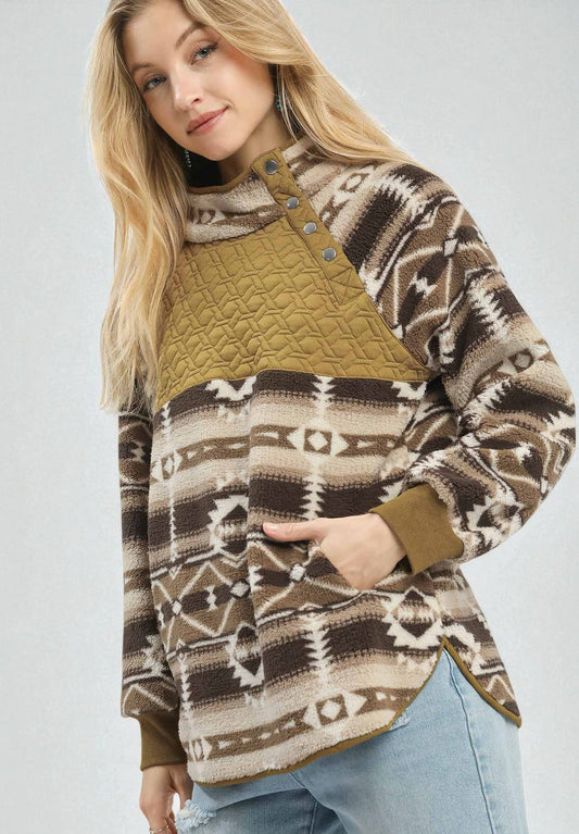 Woman wearing a patterned sweater with a quilted section on a white background