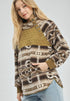 Woman wearing a patterned sweater with a quilted section on a white background
