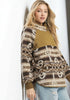 Woman wearing a patterned sweater with a plain background
