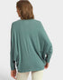 Person wearing a teal sweater on a white background