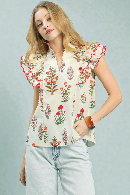 Woman wearing a floral blouse with a plain background
