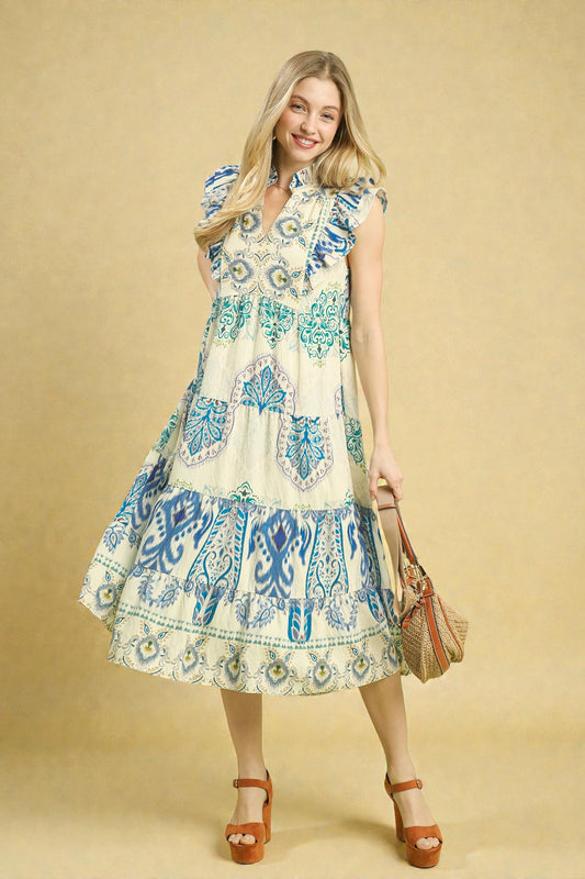 Woman wearing a patterned dress against a beige background