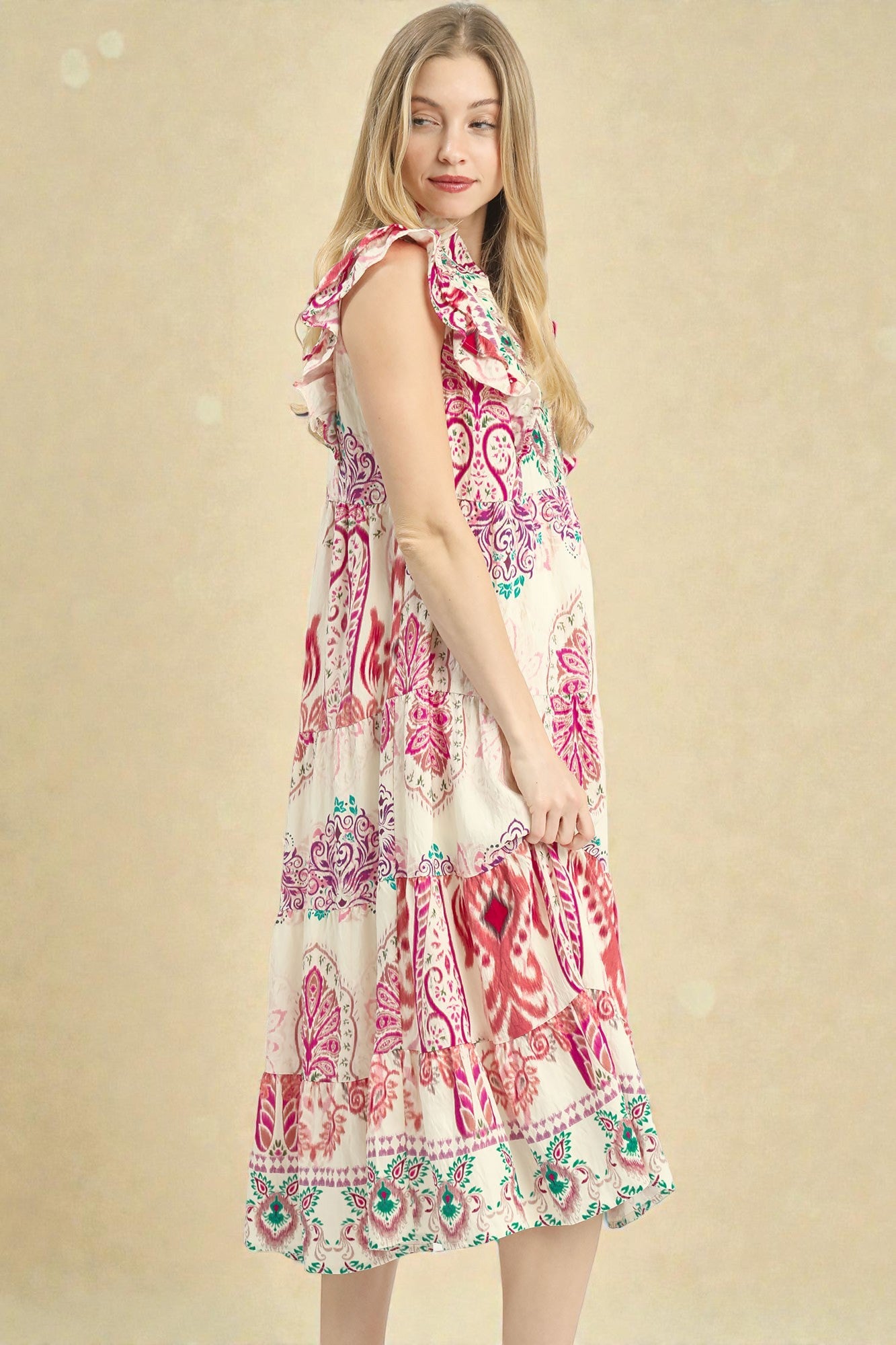 Woman wearing a colorful patterned dress on a beige background