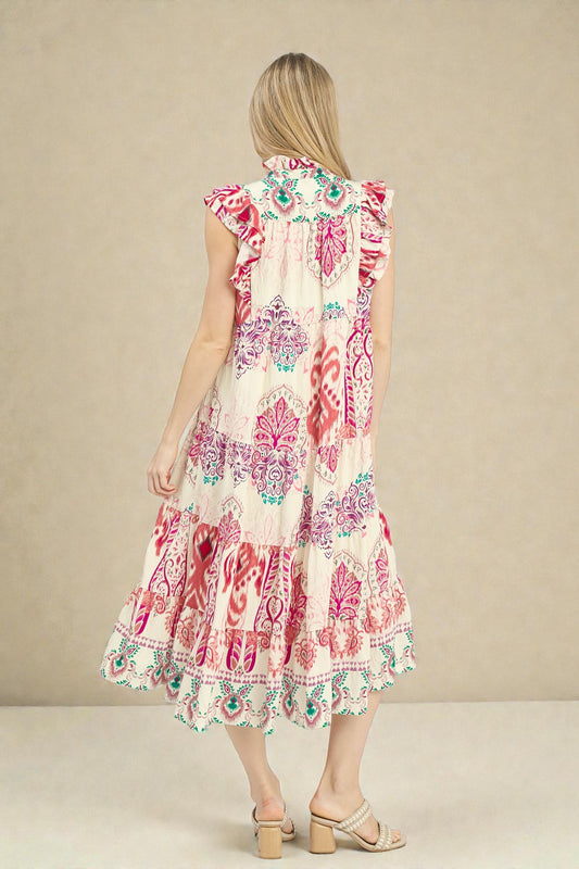 Woman wearing a patterned dress with a beige background