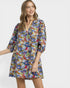 Woman wearing a colorful floral dress on a white background