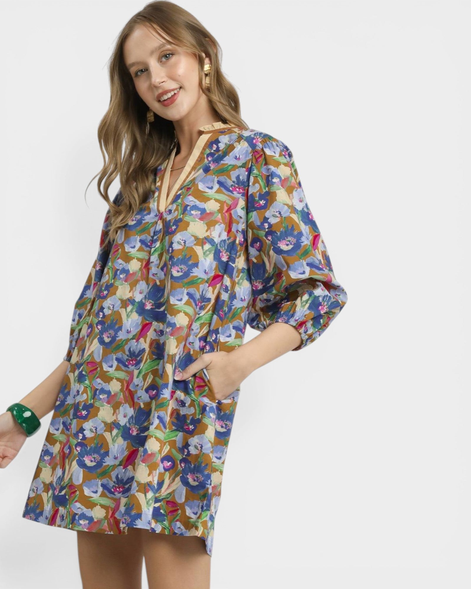 Woman wearing a colorful floral dress on a white background