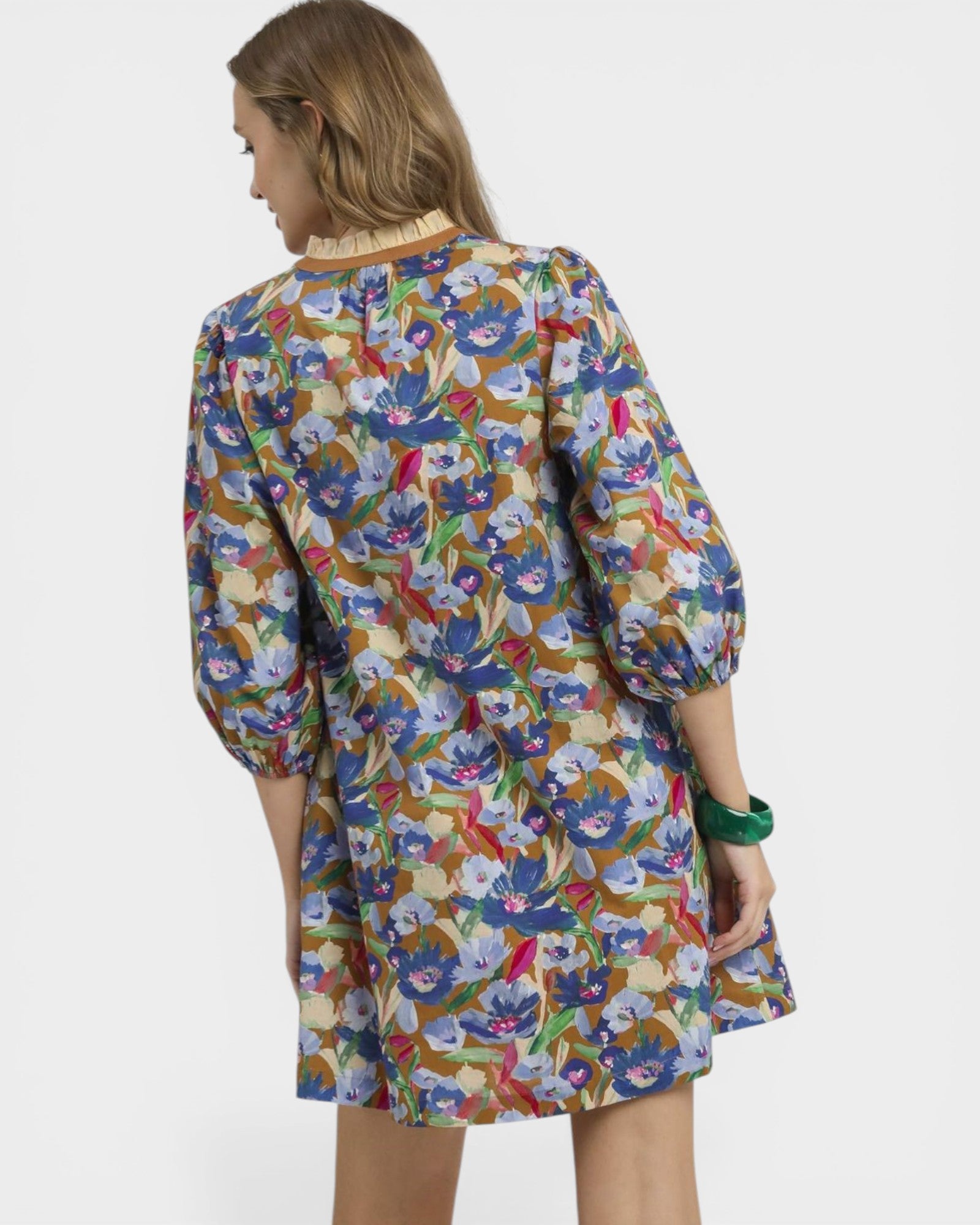 Woman wearing a colorful floral dress on a white background