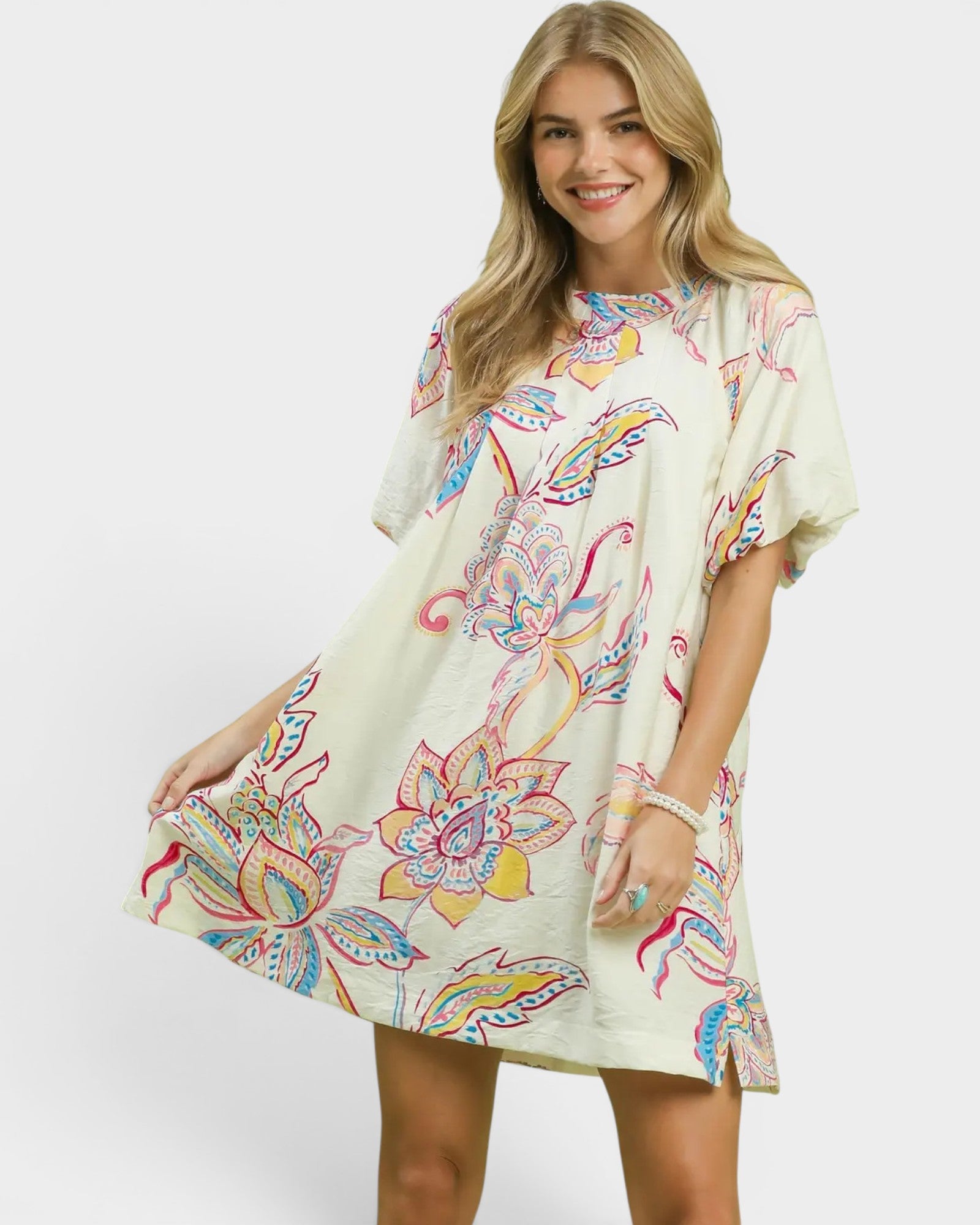 Woman wearing a colorful floral dress on a white background