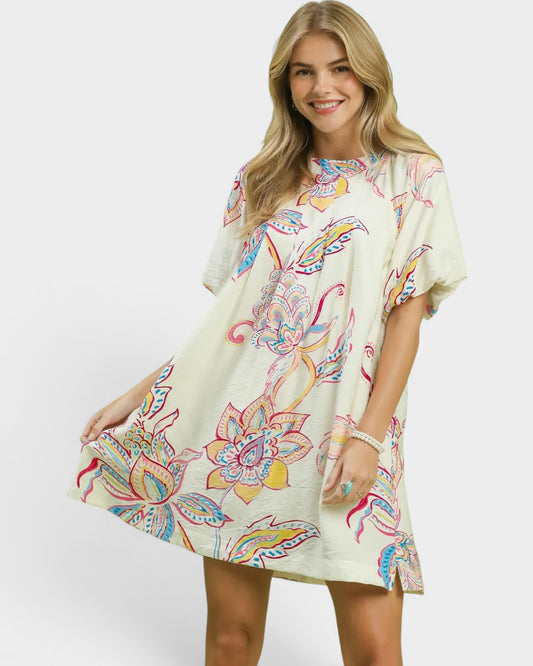 Woman wearing a colorful floral dress on a white background