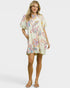 Woman wearing a colorful patterned dress on a white background