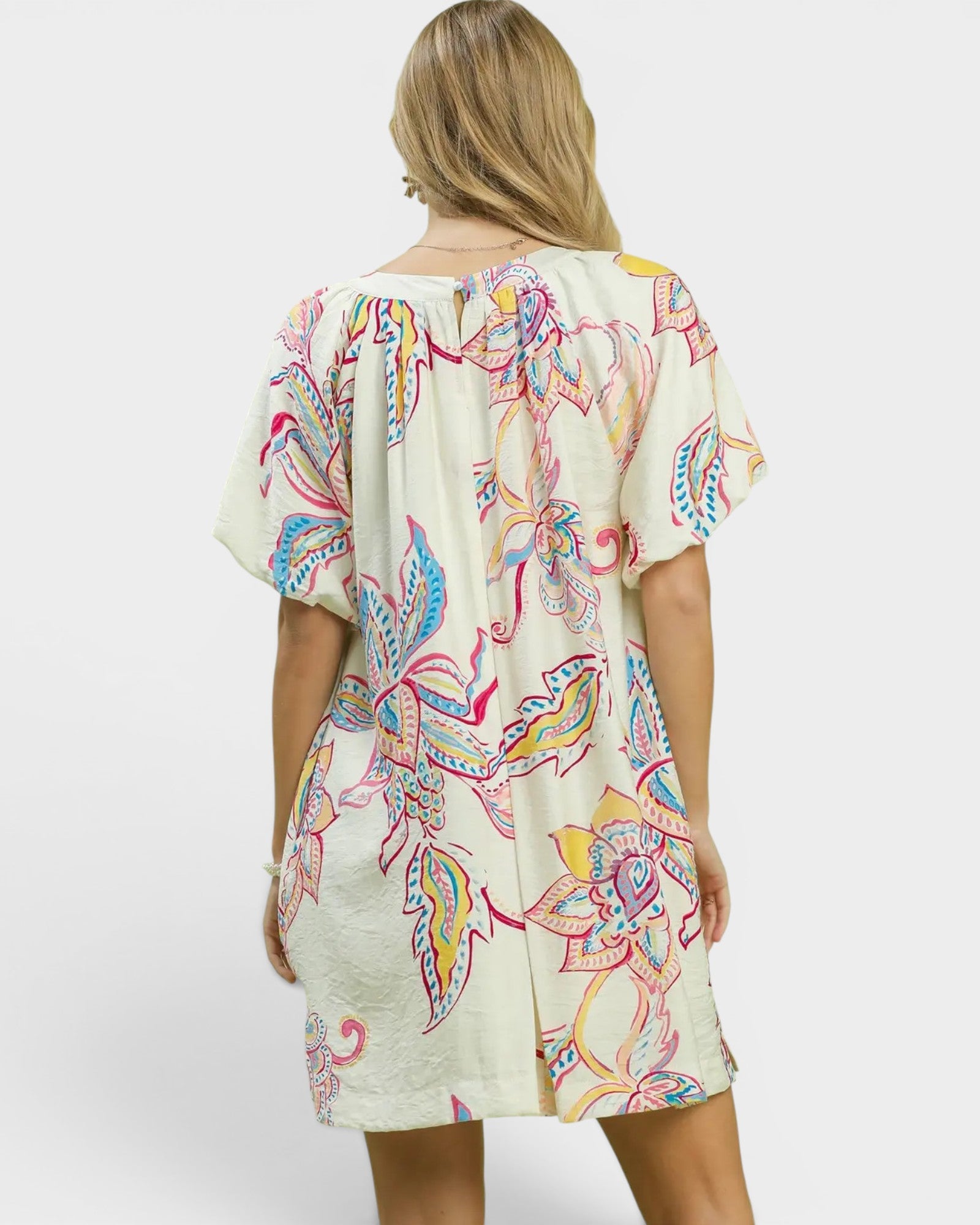 Woman wearing a colorful patterned dress on a white background