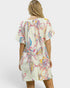 Woman wearing a colorful patterned dress on a white background