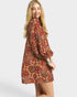 Woman wearing a patterned dress on a white background