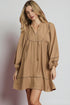 Woman wearing a brown dress with a plain background