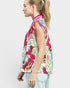 Woman wearing a sleeveless floral top on a white background