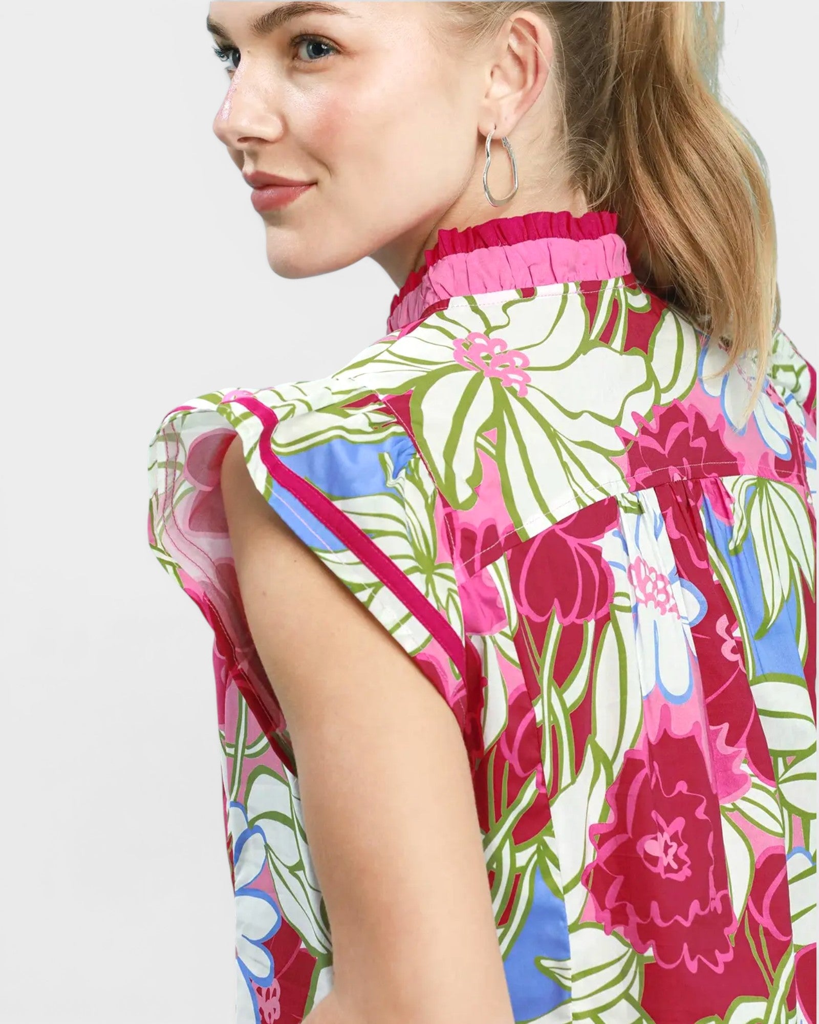 Woman wearing a colorful floral dress with a white background