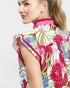 Woman wearing a colorful floral dress with a white background