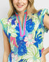 Woman wearing a colorful floral blouse with a white background