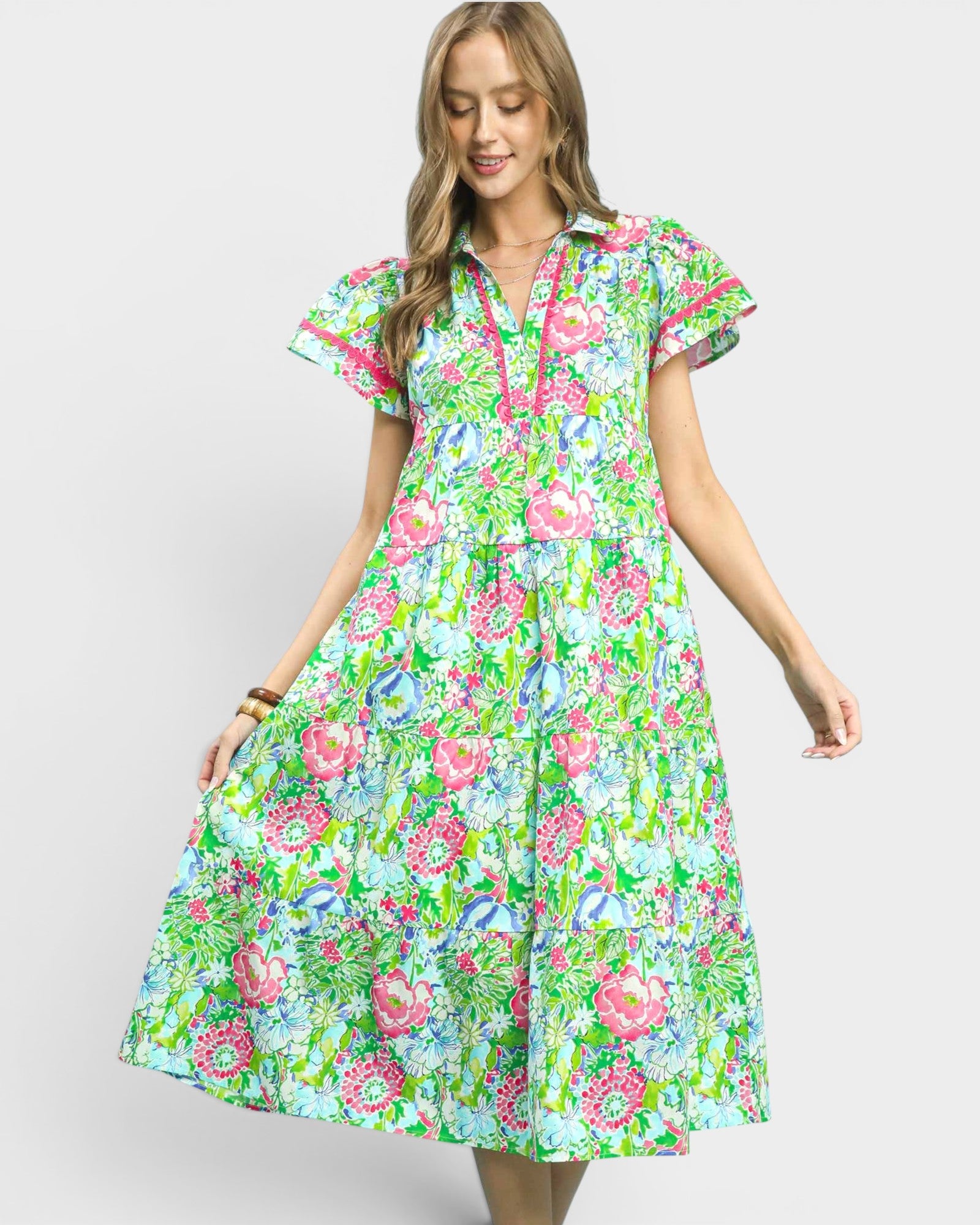 Woman wearing a colorful floral dress on a white background